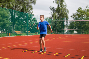 Fototapeta premium An athlete does special running exercises on a ladder.