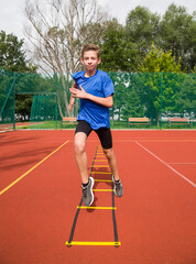 An athlete does special running exercises on a ladder.