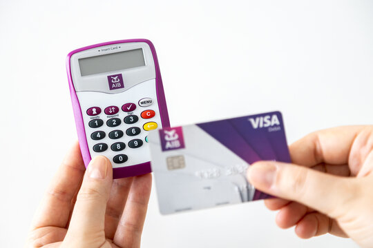 Hands using AIB (Allied Irish Banks) card reader for internet banking access