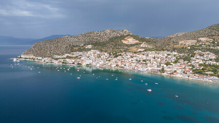 Aerial drone photo of famous seaside village small port and long sandy beach of Tolo with hotels and resorts built by the sea, Argolida, Peloponnese, Greece