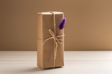 Craft gift box with lagurus on a white wooden table. Eco-friendly concept. Rustic style. Romantic...
