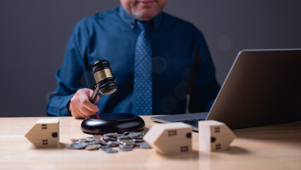 Amidst the recession, the lawyer used a gavel to finalize the housing agreement, turning the property investment and loan into a strategic business move.