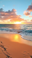 Sunrise on the beach with gentle waves and the sun emerging on the horizon