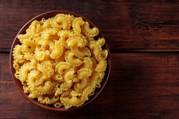 Uncooked Creste di Gallo Pasta in Bowl, Copy Space