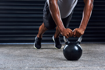 Fitness, push ups and hands man with kettlebell in gym for cardio workout, endurance challenge or muscle growth. Body, wellness and athlete on floor for performance, training or strength exercise