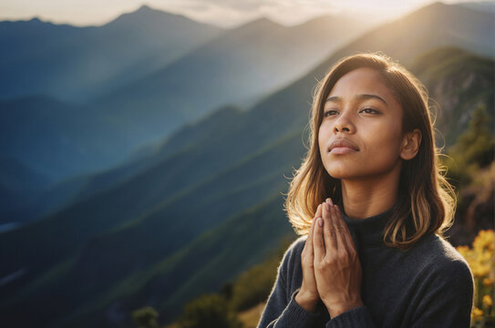 young woman praying and hoping in beautiful nature, religious concept 