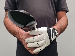 Closeup of a Golfer Holding a Golf Club With a White Glove
