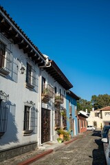 beautiful antique looking homes with iron bars and juliet balconies in south american town
