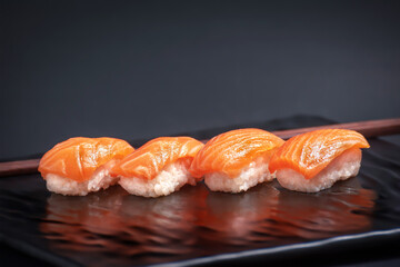 Salmon Sushi on Black Plate