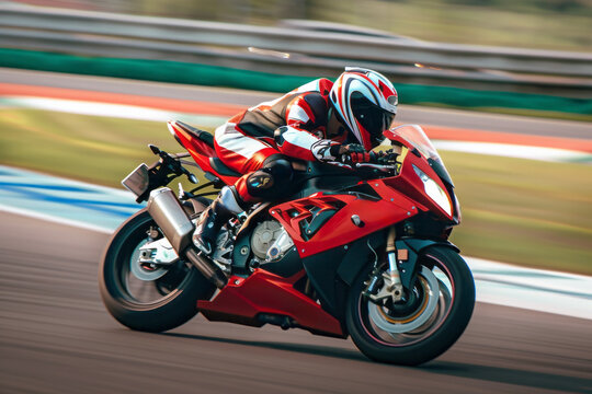 Super Motorcycle racing on the track while riding a fast red sports bike close up
