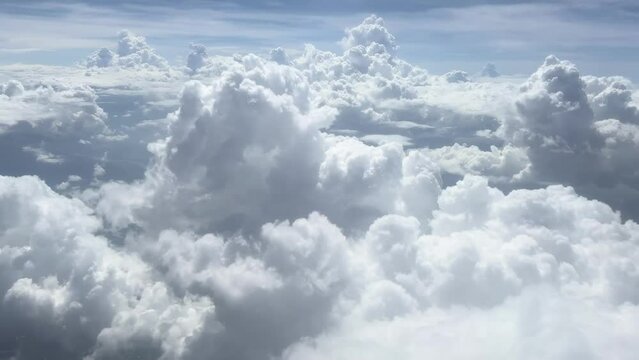 Majestic clouds, view from the window of the plane. Flying among the clouds. Beautiful skyscape. Traveling by plane