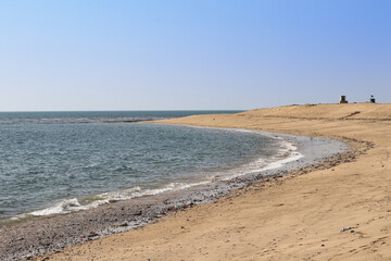 Seascape good clear blue sky and blue water island sunny. Sea wave slow water splash shore golden sandy beach summer. Travel tropical beach vacation relax seaside paradise. Mul Dwarka india gujarat.