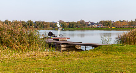 Landscape in the countryside by the lake on a sunny October day. A quiet place to relax by the water.