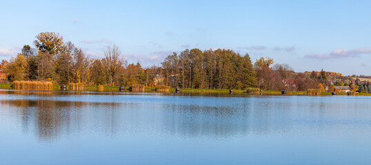 Landscape in the countryside by the lake on a sunny October day. A quiet place to relax by the water.