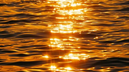 Golden sunset reflections on rippling water surface