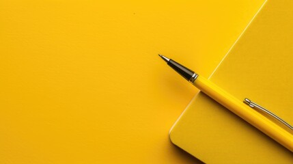Yellow pen and notebook on yellow table for writing or blogging