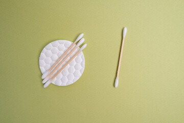 Bamboo cotton buds and cotton pads on a colored background. Biodegradable ear plugs. Eco product
