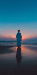 Fototapeta premium a man stands on a beach with the sun setting behind him.