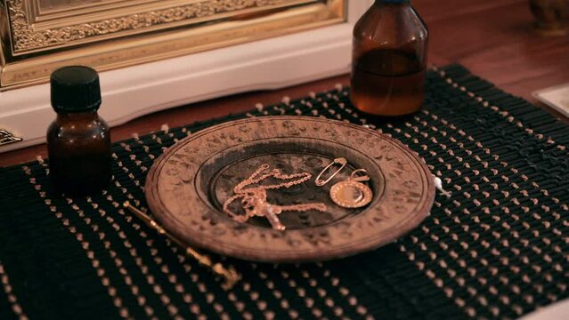 Orthodox worship. baptism artiboots. anointing oil, gold pendant cross, earrings, pin from the evil eye on a wooden tray