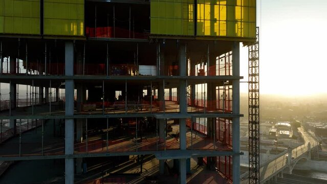 Aerial shot of a new high-rise building under construction at sunrise
