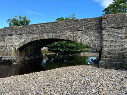 Stone bridge arch over water