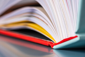 Opened hard cover book pages with toned color background, close-up view