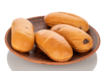 Several fragrant buns on a clay plate, close-up, isolated on a white background.