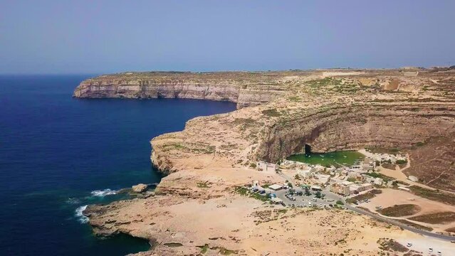 Drone footage fly towards Dwejra inland sea in Gozo island in Malta