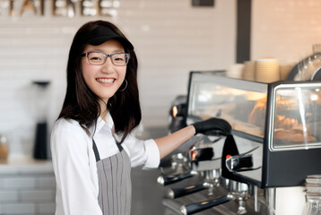 young asian barista happy to making coffee in small survice business as part time or enterpreneur