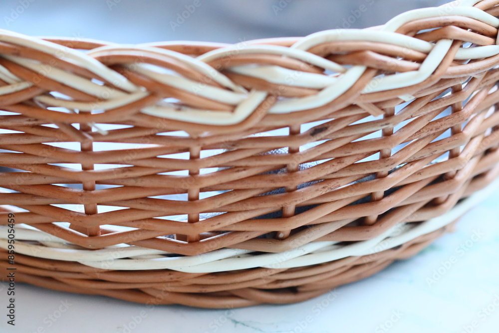 Poster a close-up view of a basket sitting on a table, potentially filled with items