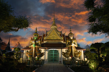 Thailand, Bangkok - couple of demon guardian gatekeepers at the Wat Arun temple of dawn during...