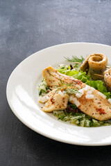 Marinated herring fillets with dill on wooden table
