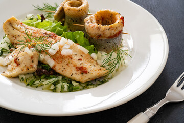 Marinated herring fillets with dill on wooden table
