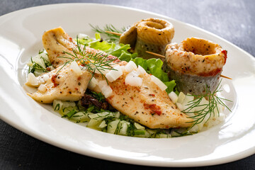Marinated herring fillets with dill on wooden table
