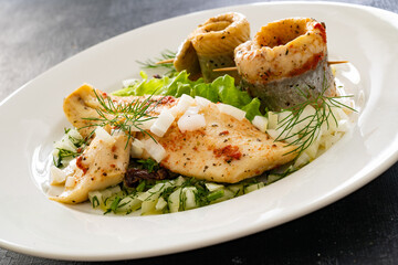 Marinated herring fillets with dill on wooden table
