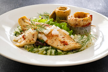 Marinated herring fillets with dill on wooden table
