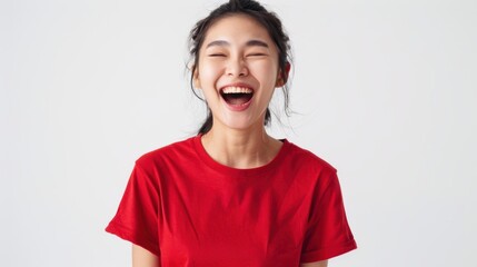 Isolated white backdrop with a happy, attractive young Asian woman wearing a red t-shirt. joyful soccer supporters