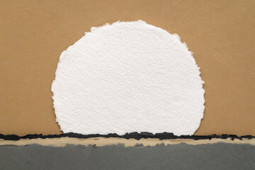 moon or sun rising abstract landscape in earth tones with blank circular watercolor paper