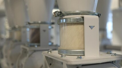 Modern flour mill. Manufacture of flour and cereals. Close up of wheat milling moving through the pipes. Production of wheat flour. Wheat flour milling equipment at the plant. Grain equipment.