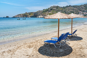 View of the beach with chairs and umbrellas. Crete island landscape. 