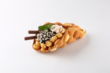 Hong kong or bubble waffle with ice cream and fruits isolated on white background