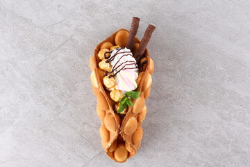 Hong kong or bubble waffle with ice cream and fruits isolated on white background