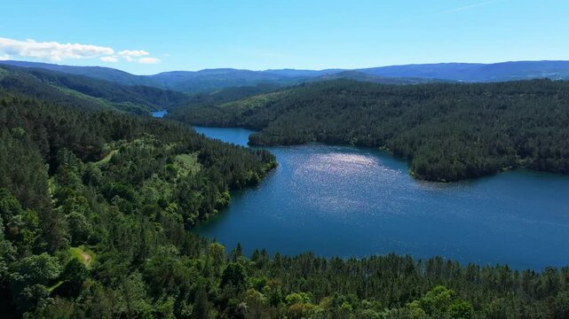 Aerial footage of Rio Avia Lake And Encoro de Albarellos reservoir on a sunny day in Ourense, Spain