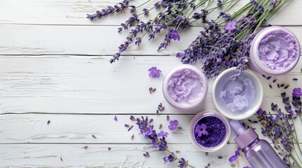 Purple lavender flowers and skincare products on white wooden surface seen from above