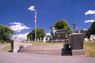 Grave of Chester A. Arthur, 21st President of the United States, Albany, NY. Springtime, bright sunshine, flag in breeze.