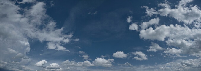 Fototapeta premium Russia. South of Western Siberia. Panorama of the daytime summer sky with cumulus clouds over the fields of Kuznetsk Alatau.