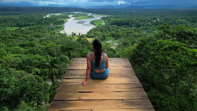 Aerial view of woman enjoying the views of Pastaza River from Indichuris viewpoint in Puyo, Amazonia, Ecuador