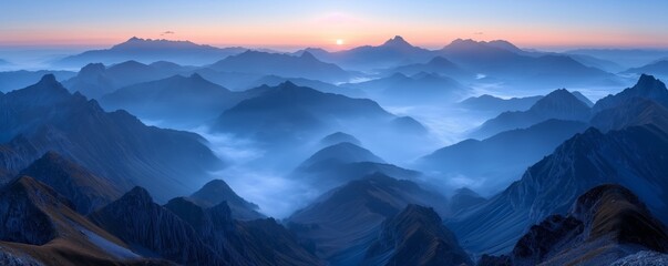 A captivating sunset casting a warm glow over multiple layers of mist-covered mountain ranges, with the horizon fading into a beautiful blend of soft, peaceful colors.