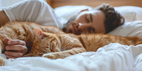 Young man and cat sleeping together on the bed
