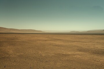 Fototapeta premium Barren desert landscape depicting solitude and vastness under a clear sky